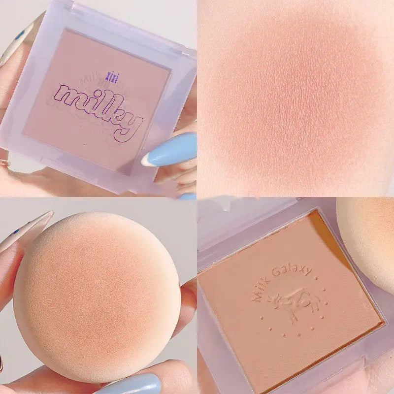 Makeup product with 'milky' branding, including a compact case, powder, and sponge applicator.
