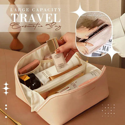 Large capacity travel cosmetic bag with various products on a table.