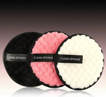 Set of three round clean sponges in black, pink, and white with textured surfaces