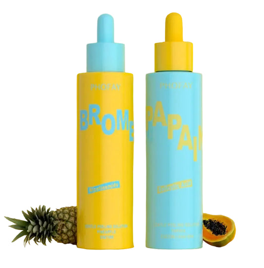 Two colorful bottles labeled 'Bromeliad' and 'Papaya' on a yellow background with a pineapple and papaya.