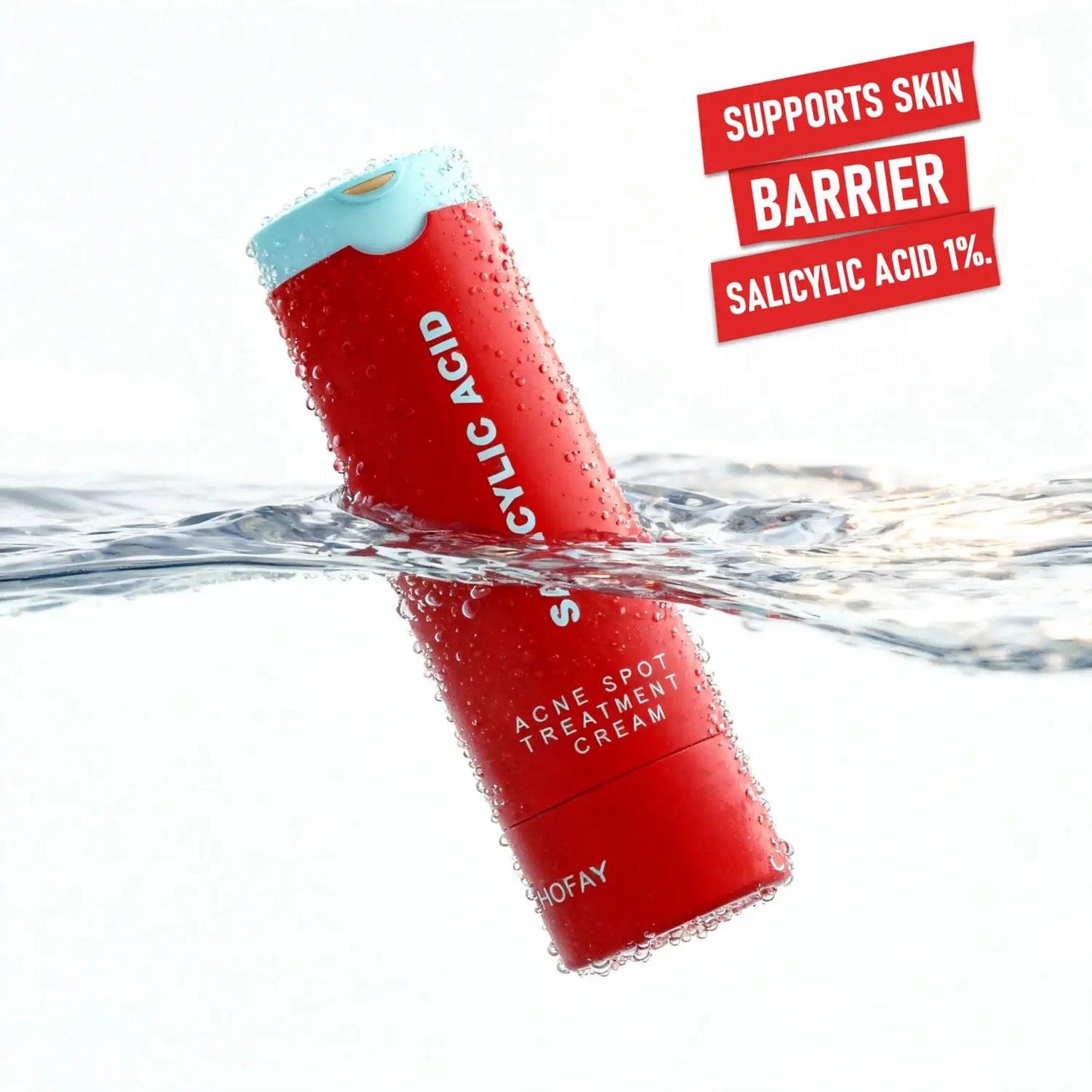 Red bottle of Acne Spot Treatment Cream with water droplets on a white background