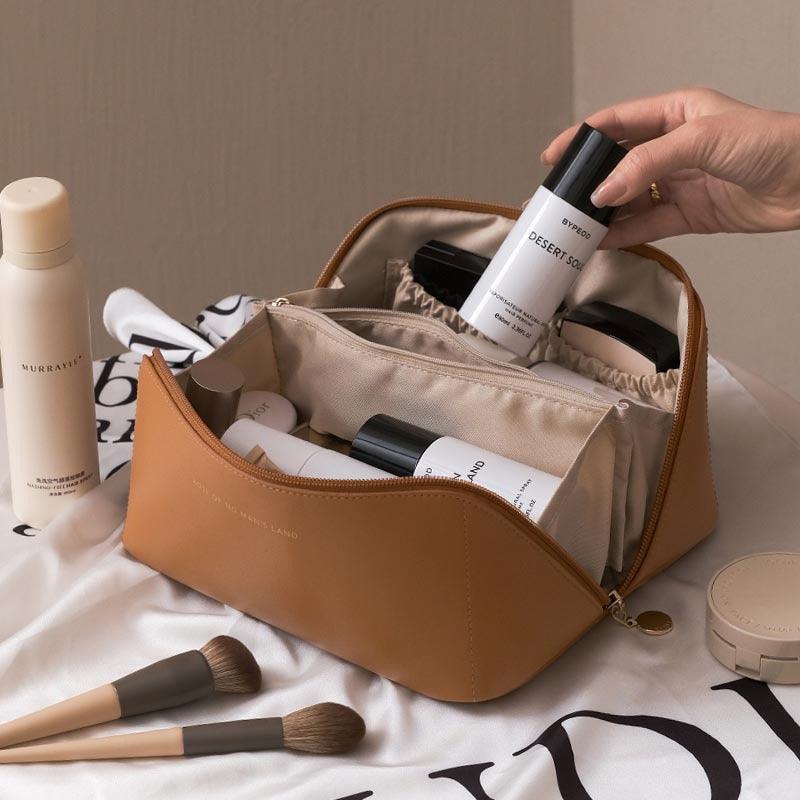 Cosmetic bag with skincare products and makeup brushes on a light background