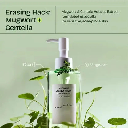 Bottle of Mugwort Zero Film Cleansing Oil with mugwort leaves on a green background