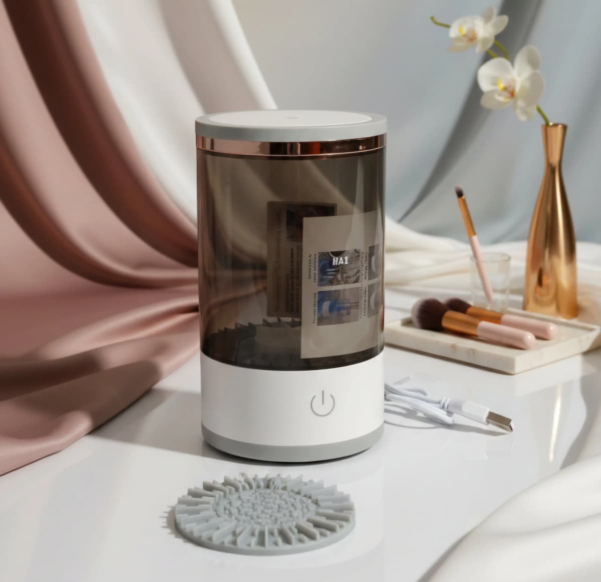 White and clear cylindrical electrical brush cleaner on a white surface with a blurred background